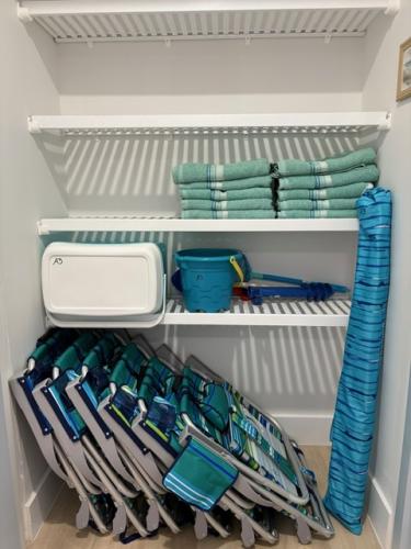 Beach towels, chairs, umbrella and cooler